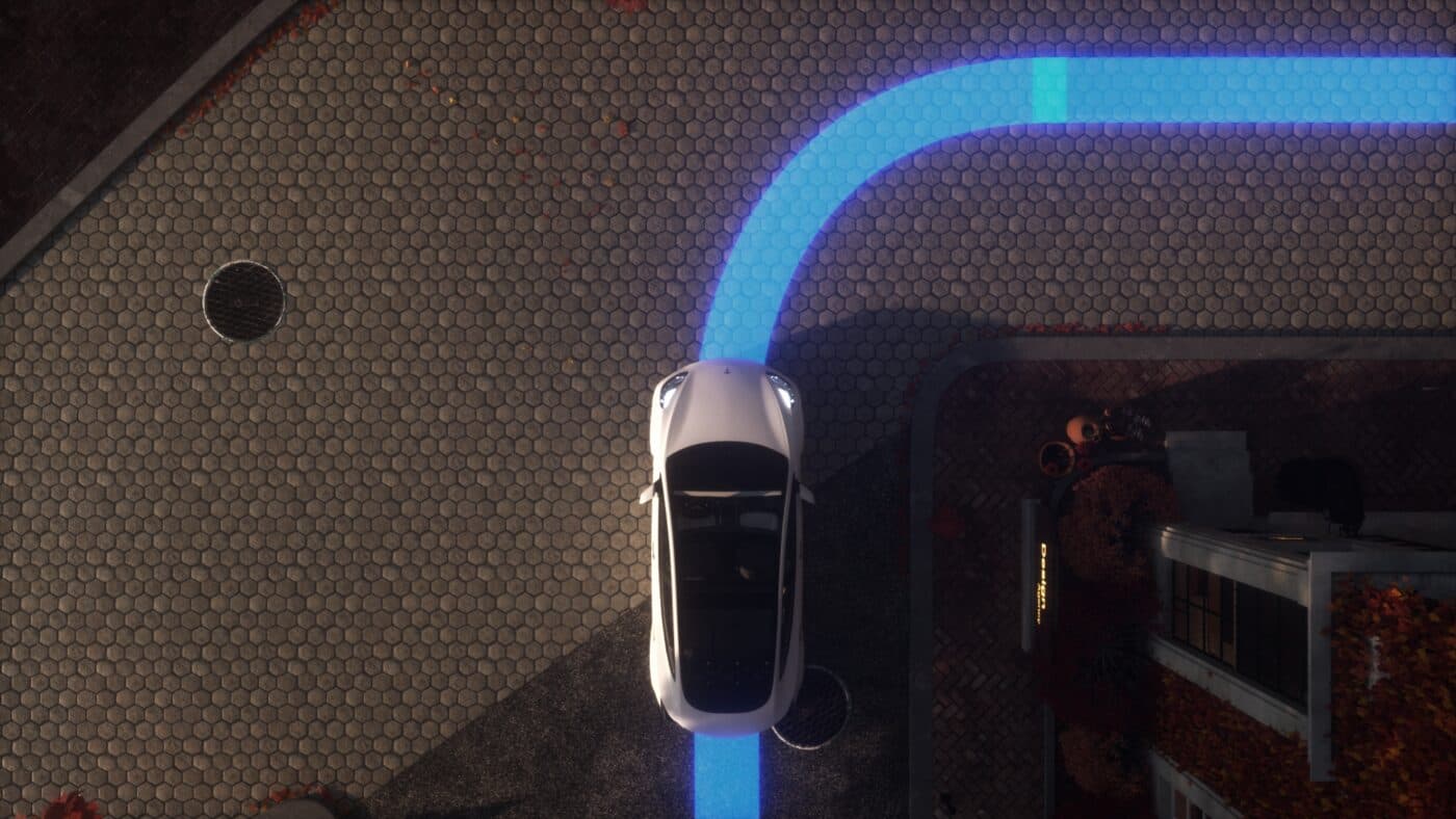 Bird's-eye view of the car with its blue autopilot path curving ahead